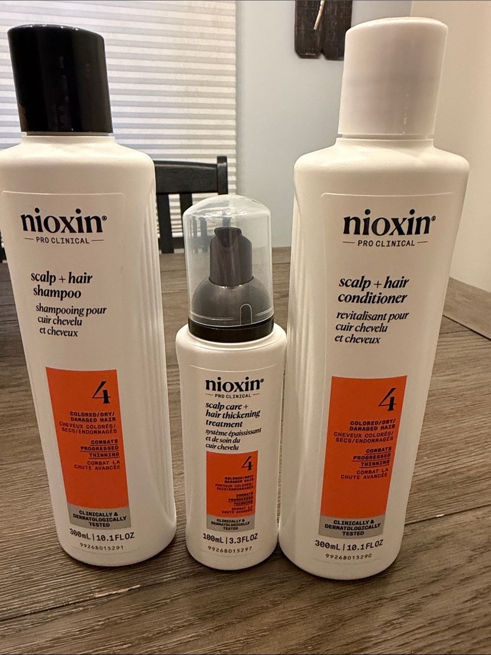 Nioxin Pro Clinical System 4 Scalp + Hair Care Trio in White with Orange Accents